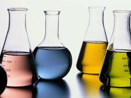 Four bottles of different color chemical fluid.